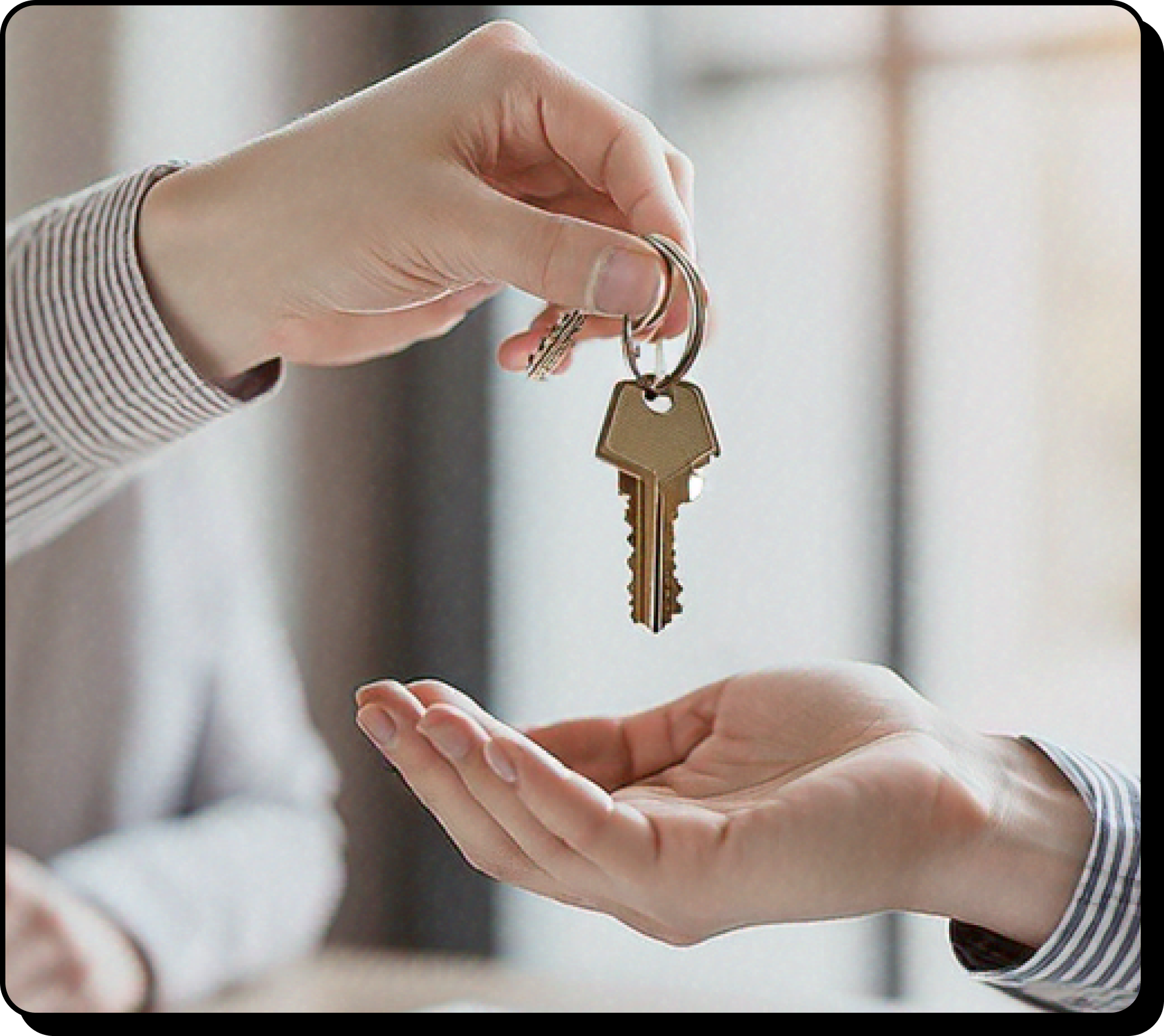 A person handing over keys to another